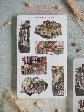 Sheet of "Torn Paper Stickers - April 2026" featuring a nostalgic collage of highly detailed, sepia-toned architectural street scenes.