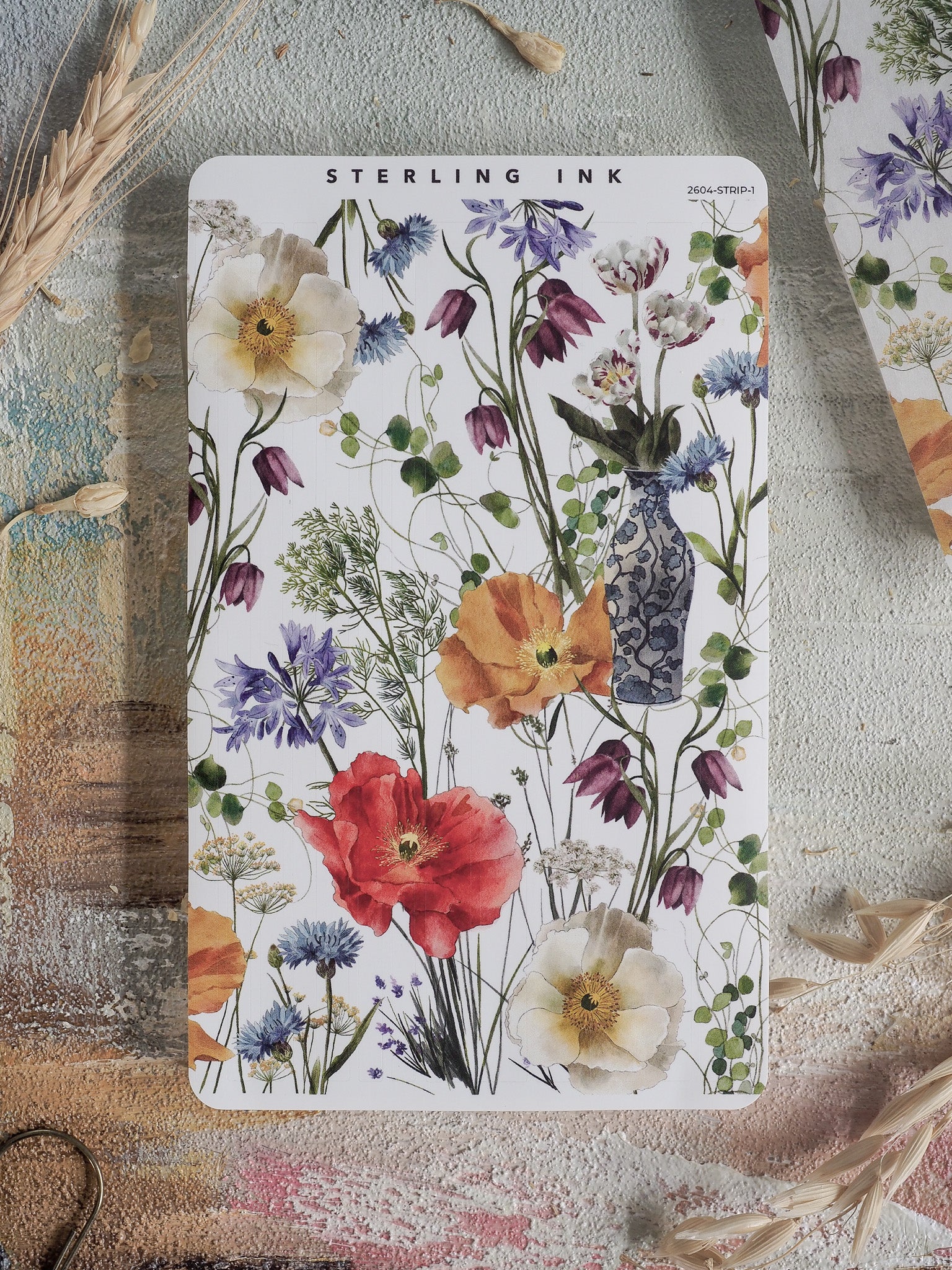 Vibrant sticker strip featuring a watercolor arrangement of spring blooms, including striking red poppies, delicate blue hyacinths, and lush floral greenery.