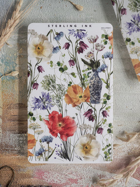 Vibrant sticker strip featuring a watercolor arrangement of spring blooms, including striking red poppies, delicate blue hyacinths, and lush floral greenery.