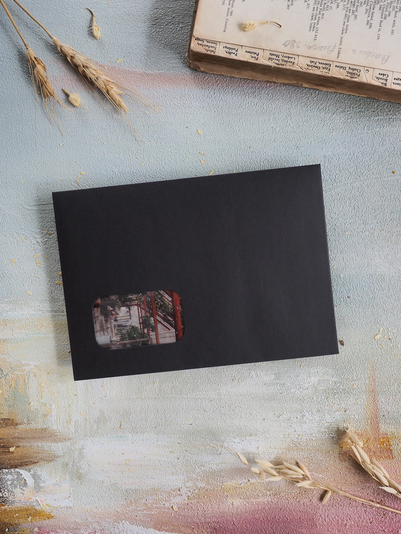 Minimalist black planner component for the April 2026 subscription kit, featuring a centered, warm-toned architectural photo inset.