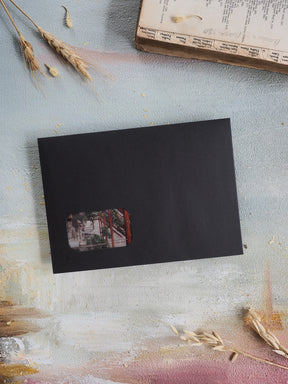 Minimalist black planner component for the April 2026 subscription kit, featuring a centered, warm-toned architectural photo inset.