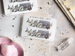 Decorative April 2024 month sticker with a vintage aesthetic, printed in black ink featuring engraved architectural details, delicate floral motifs, and charming butterflies.