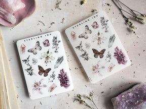 Botanical sticker sheet featuring natural elements, including detailed illustrations of purple flowers, various butterflies, herbs, and mineral crystals.
