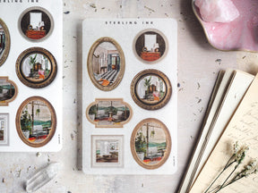 A decorative sheet of vintage picture frame stickers featuring detailed mini illustrations of cozy interiors, classical architecture, and nostalgic scenes.