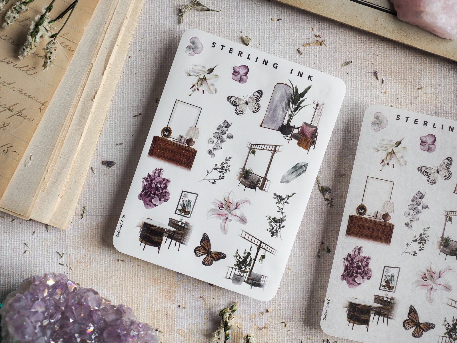 Mini sticker sheets featuring an array of watercolor botanical and home elements, including butterflies, purple floral bouquets, and delicate vintage furniture icons.