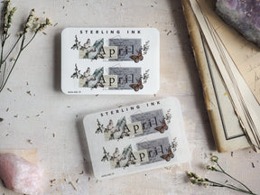 Vintage April month stickers featuring elegant butterfly illustrations, subtle architectural motifs, and spring floral details.