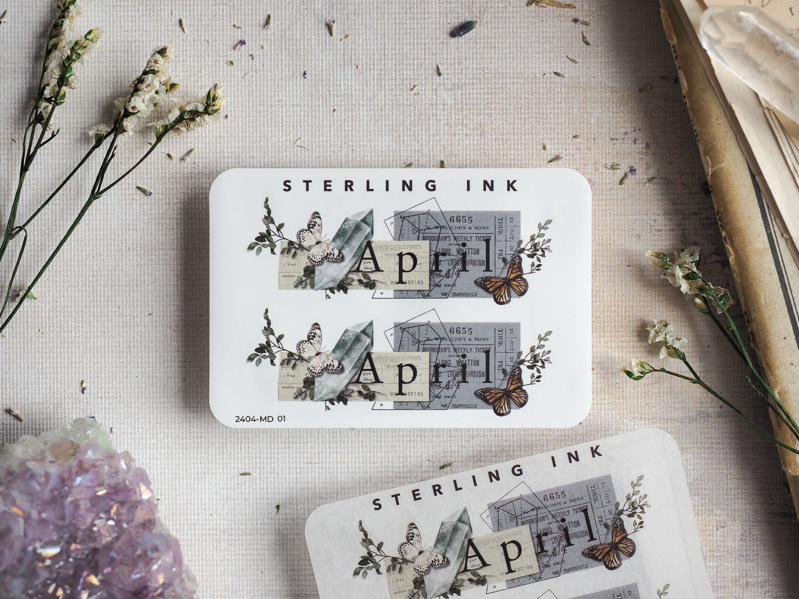 Vintage April sticker sheet featuring delicate botanical clippings, script typography, and detailed illustrations of butterflies and moths on a crisp white background.