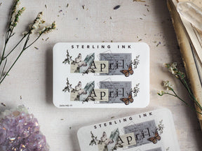 Vintage April sticker sheet featuring delicate botanical clippings, script typography, and detailed illustrations of butterflies and moths on a crisp white background.