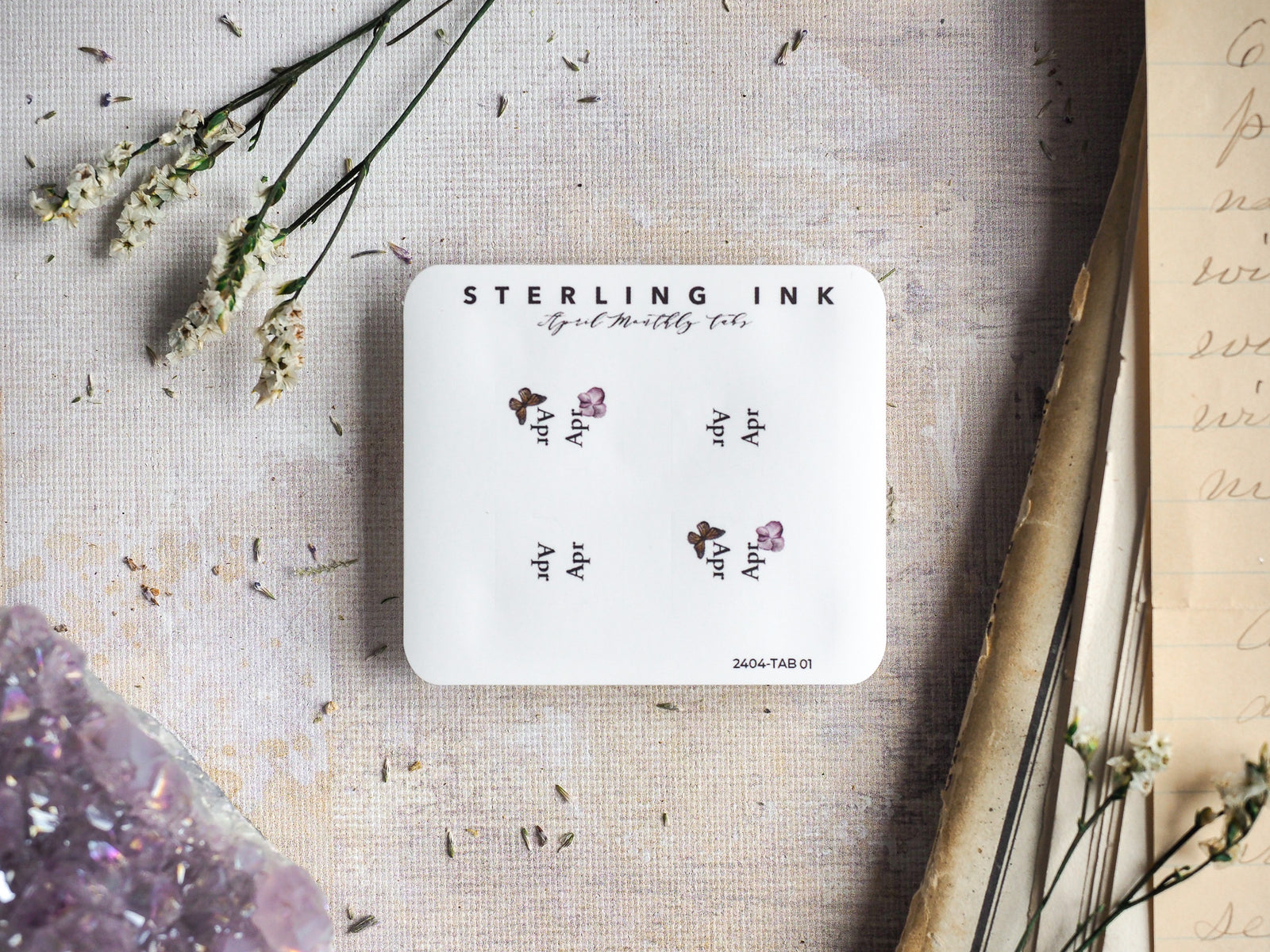 White monthly planner tabs for April 2024 from Sterling Ink, decorated with small, delicate botanical watercolor accents.