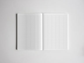 Open notebook showing clean white graph paper with precise intersecting grid lines, ideal for technical drawing, studying, or academic planning.
