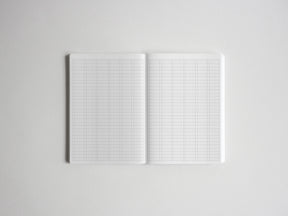 Open graph paper notebook showing two pages of crisp white, precisely gridded paper, perfect for structured drawing, technical drafting, or academic planning.
