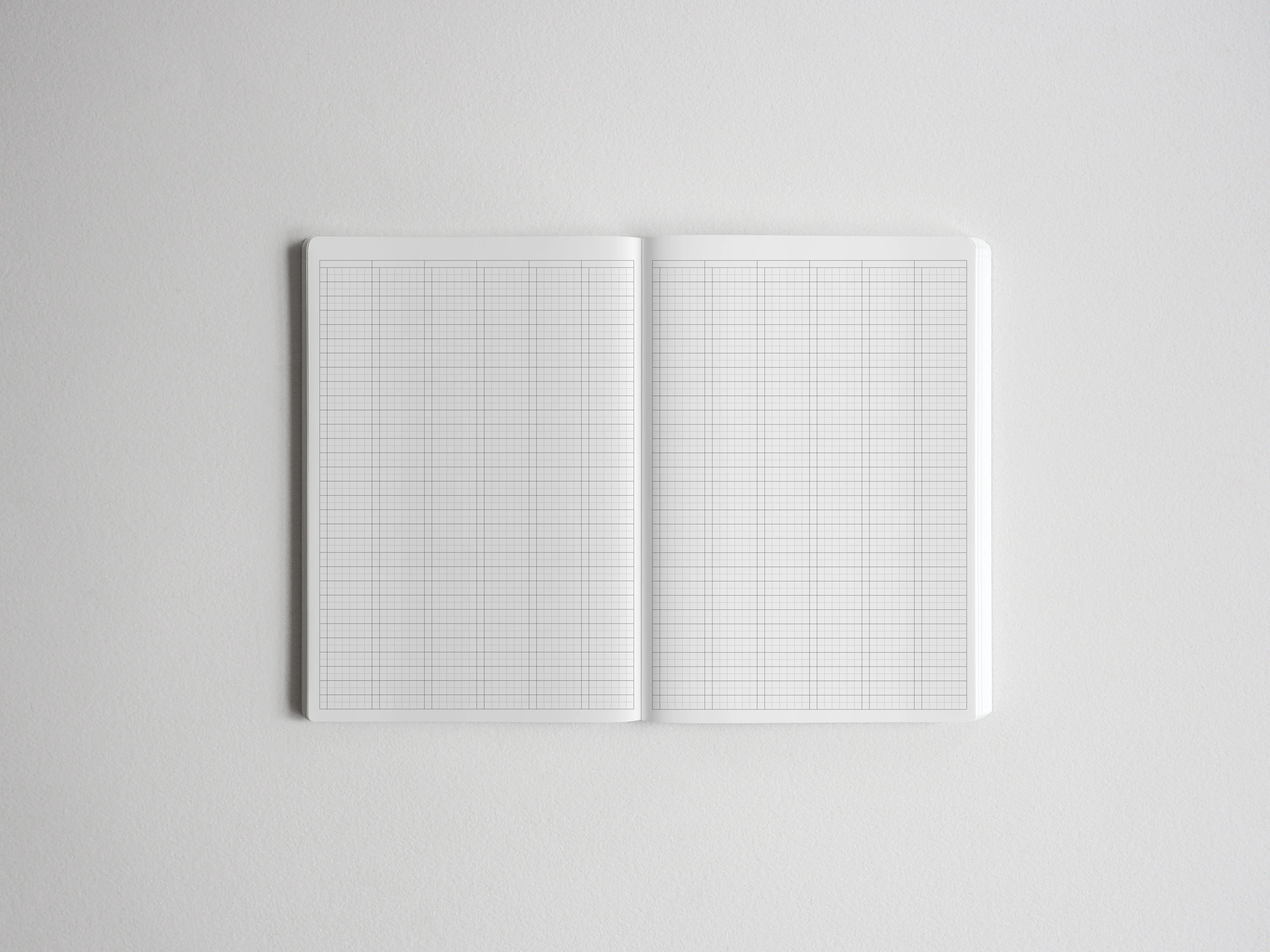 Open graph paper notebook showing two pages of crisp white, precisely gridded paper, perfect for structured drawing, technical drafting, or academic planning.