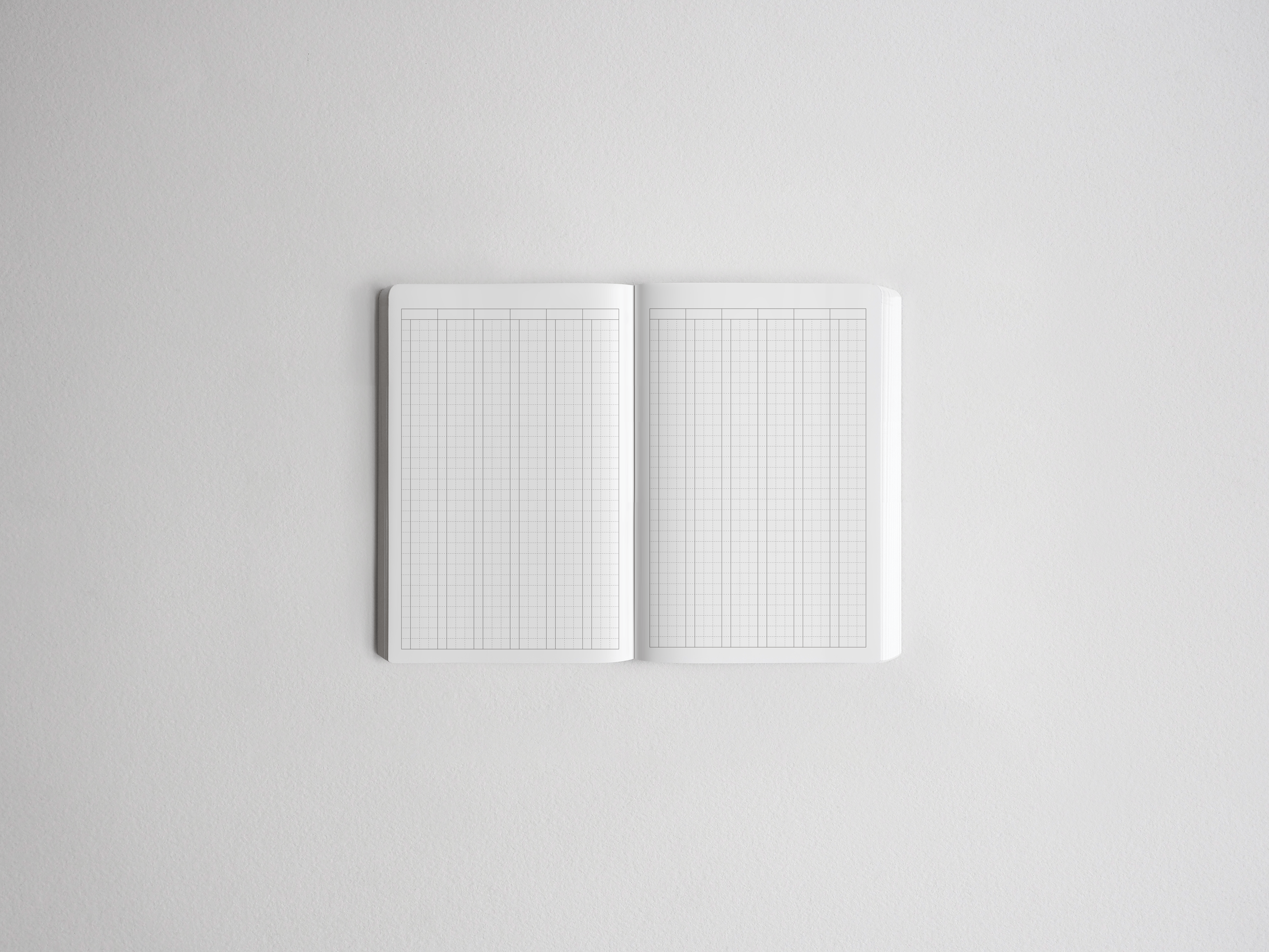 Open notebook displaying dual-layout pages with intersecting vertical and horizontal grids, ideal for versatile note-taking and planning.
