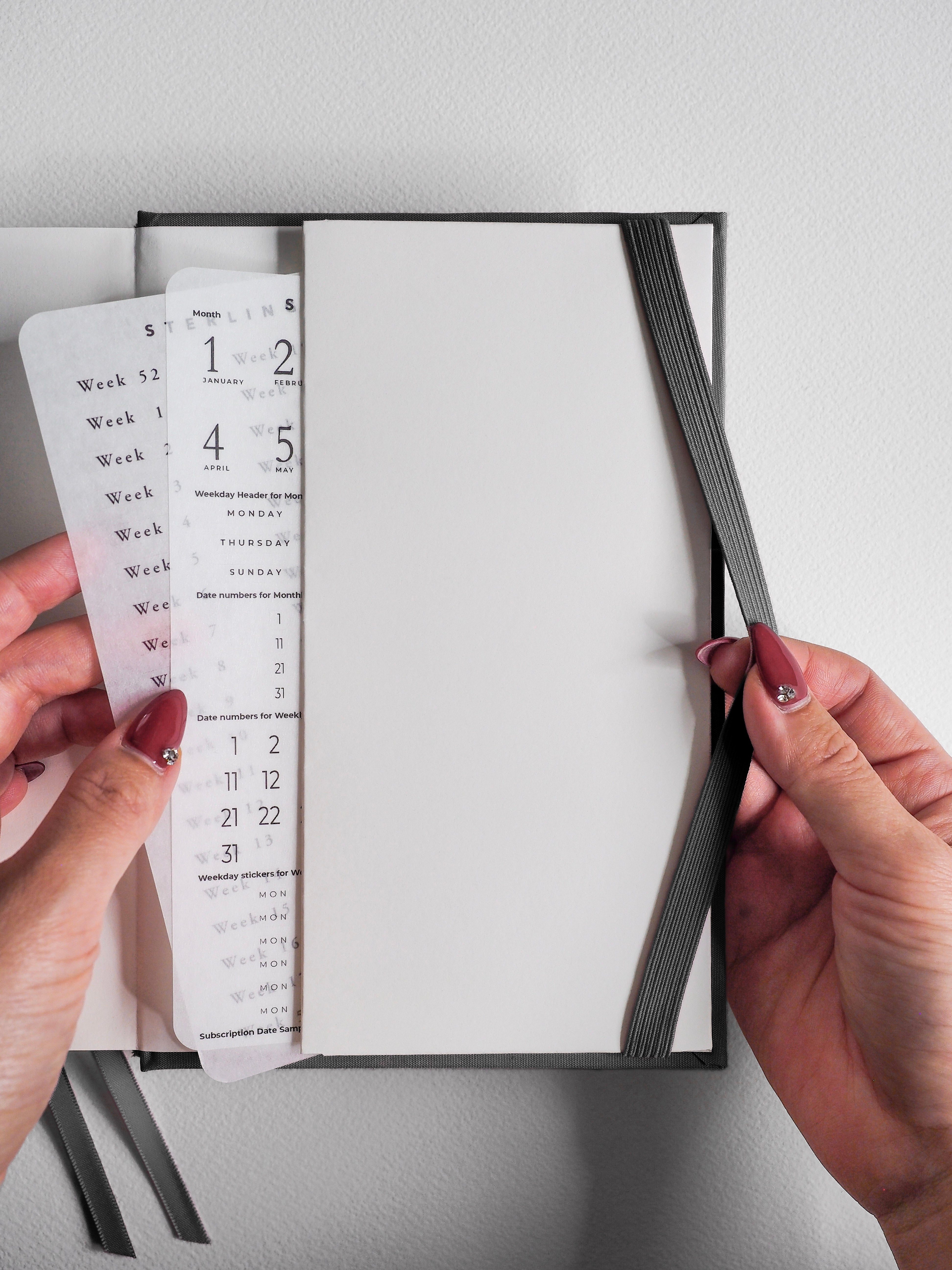 Aspirated academic planner showing open, structured pages with dated weekly and monthly templates for vertical full-year planning.