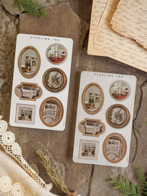 Decorative sticker sheets featuring antique, gold-rimmed photo frames surrounding rustic and nostalgic interior scenes perfect for scrapbooking and journaling.