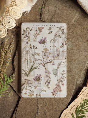 Muted botanical decorative sheet featuring a vintage, elegant arrangement of pale purple lavender and various pressed wildflowers printed on cream craft paper.