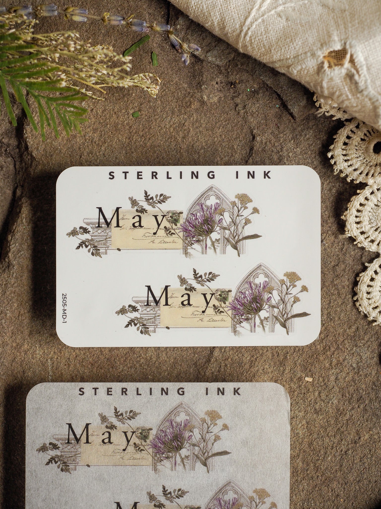 Decorative May sticker featuring vintage botanical engravings of lavender and wildflowers, printed in delicate sepia tones with natural green accents.