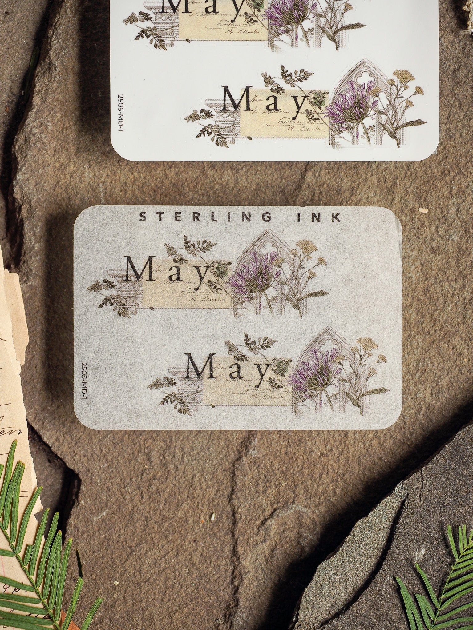 Charming May month sticker featuring rustic, vintage botanical illustrations of purple spring flowers and lettering, perfect for journaling or planners.