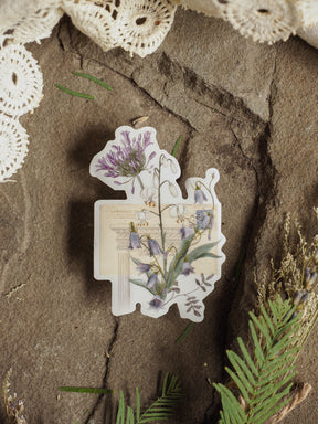 Vintage botanical vinyl sticker featuring an illustration of purple lavender, blue wildflowers, and greenery on an aged, printed background.
