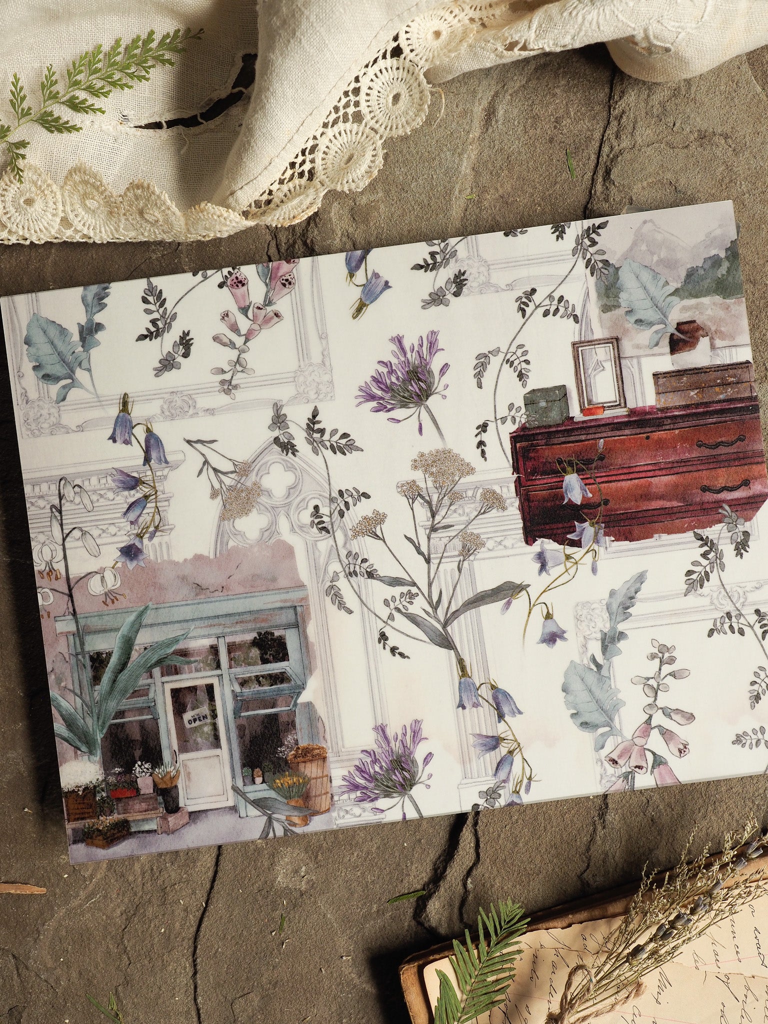 Detailed botanical illustration featuring delicate purple lilac blooms, scattered foliage, and pastel architectural elements layered over a sophisticated vintage wallpaper design.