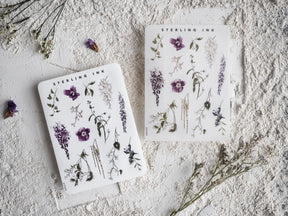 Detailed botanical sticker sheet featuring various sketches of purple and pink flowers, delicate stems, and natural meadow elements.