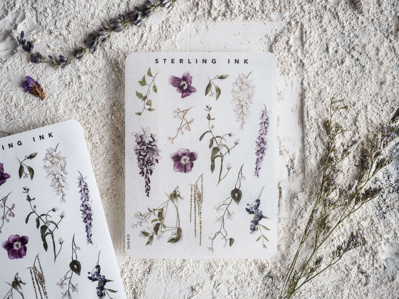 Botanical sticker sheet featuring detailed illustrations of purple lavender, small white wildflowers, and various shades of green foliage elements.