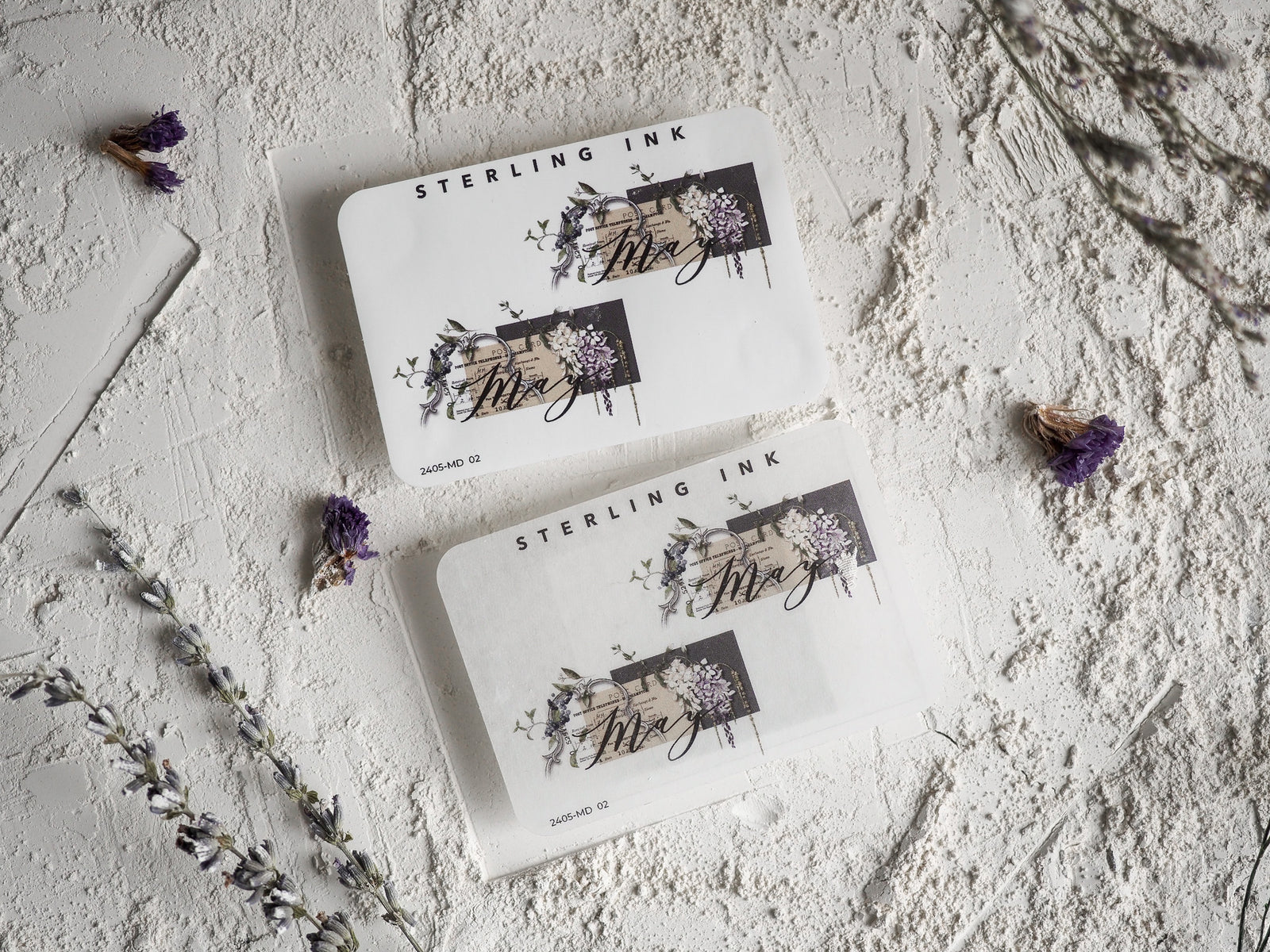 Elegant cream-colored May month stickers featuring watercolor floral clusters, grapes, and delicate botanical designs with "Sterling Ink" branding.