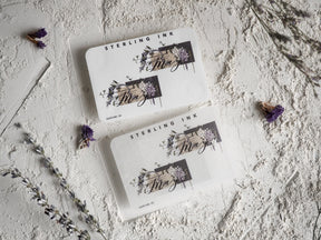 Elegant cream-colored May month stickers featuring watercolor floral clusters, grapes, and delicate botanical designs with "Sterling Ink" branding.