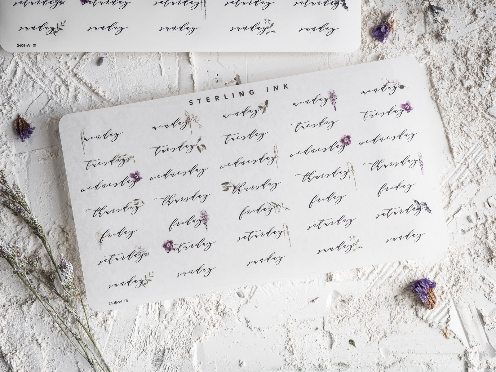 Set of decorative weekday stickers featuring the days of the week printed in a charming, handwritten script style for May 2024 planning.