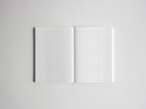 Open notepad featuring two distinct pages: a sectioned ruled page on the left and a square-grid graph page on the right, perfect for planning, journaling, and tracking.
