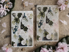 Two matching thin stickers featuring lush watercolor botanicals in soft blush pinks, deep greens, and creamy white floral patterns.
