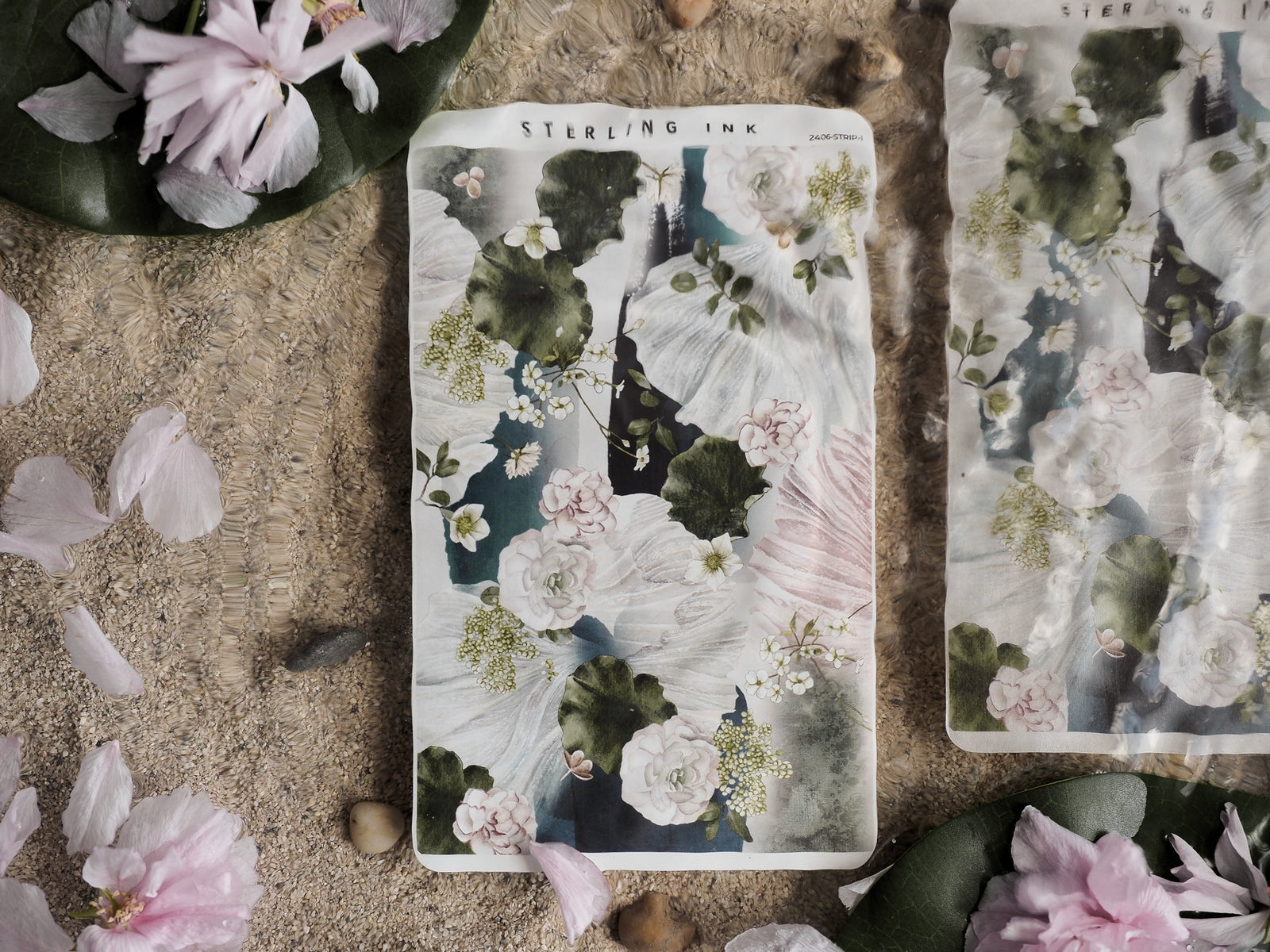 Botanical sticker sheet featuring watercolor art with soft pink and white floral blooms set against dark green leaves and creamy foliage.