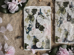 Botanical sticker sheet featuring watercolor art with soft pink and white floral blooms set against dark green leaves and creamy foliage.