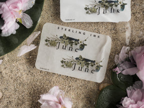 Elegant June month sticker sheet featuring detailed botanical illustrations of green foliage and delicate blue wildflowers for journaling and scrapbooking.