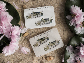 Elegant June monthly decal featuring "Sterling Ink" branding and a delicate botanical design with deep blue and sage green watercolor florals.