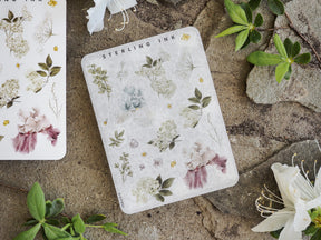 Elegant sticker sheets showcasing a romantic botanical arrangement with soft pastel watercolors of blush, blue, and sage flowers and leaves.