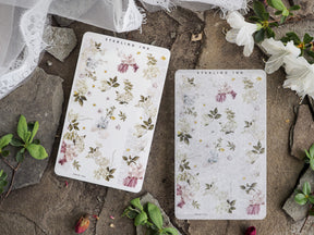 Delicate botanical washi stickers featuring scattered wildflowers and foliage in soft pink, sage, and cream tones.