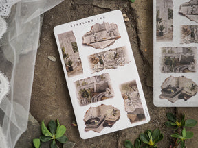Sheet of vintage "Torn Paper Stickers" featuring sepia-toned die-cuts mimicking aged photographs of architectural details, potted plants, and rustic ephemera.