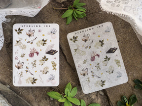 Pastel sticker sheets featuring miniature botanical elements, including tiny teapots, dried florals, delicate herbs, and scientific illustration icons.