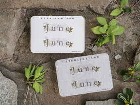 Cream-colored month stickers proclaiming "June," featuring an elegant, vintage aesthetic with delicate botanical accents ideal for journaling or scrapbooking.