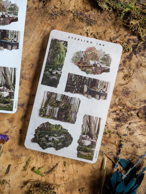 Sheet of vintage "Torn Paper Stickers - June 2025" featuring rustic illustrations of miniature houses, overgrown facades, and natural woodland scenes.
