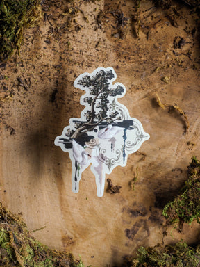 Ornate die-cut sticker featuring two graceful white cranes standing by a detailed dark tree within an antique, decorative scrollwork frame.