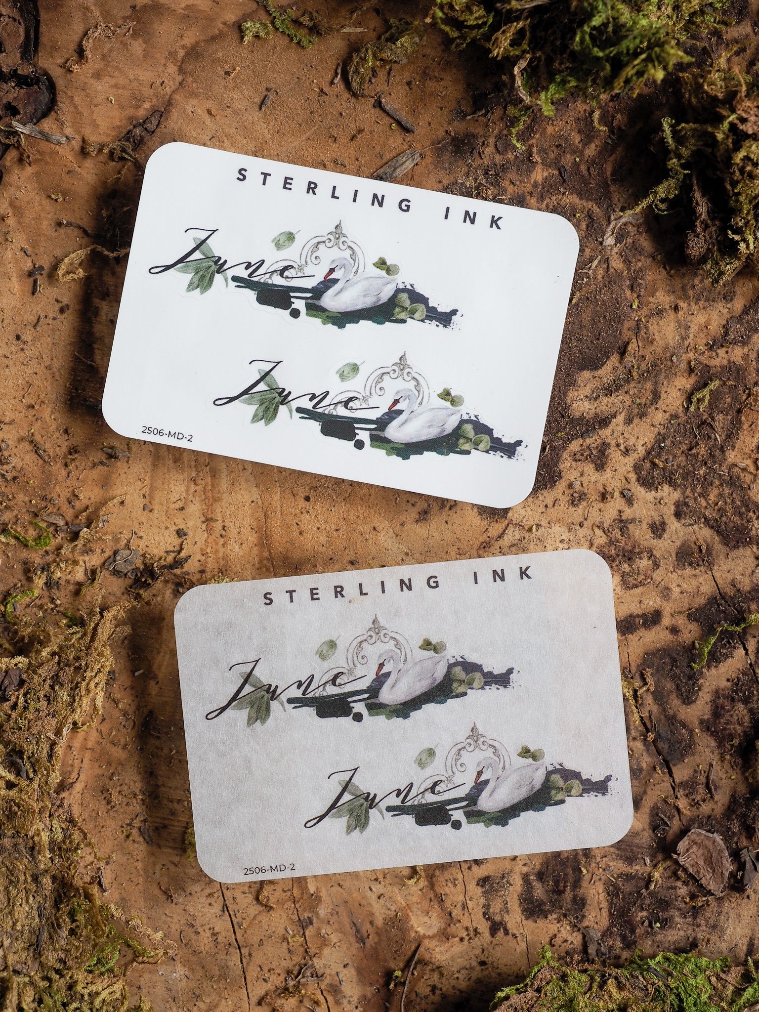 Elegant June 2025 month sticker featuring a delicate script and detailed illustration of swans amidst lush greenery.