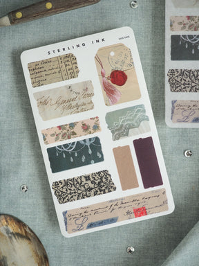 Vintage ephemera sticker sheet with patterns mimicking antique documents, featuring floral designs, distressed text labels, and solid craft tape strips for journaling and scrapbooking.