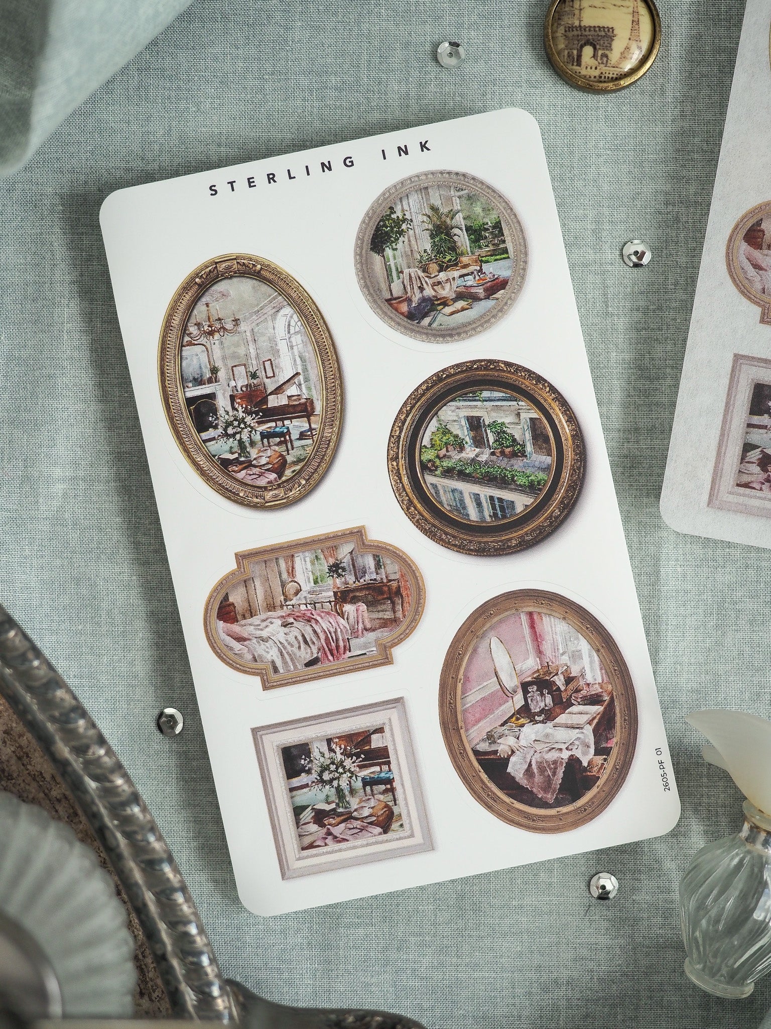 Decorative sticker sheet from STERLING INK featuring an array of ornate, vintage picture frames displaying classical interior scenes of elegant rooms.