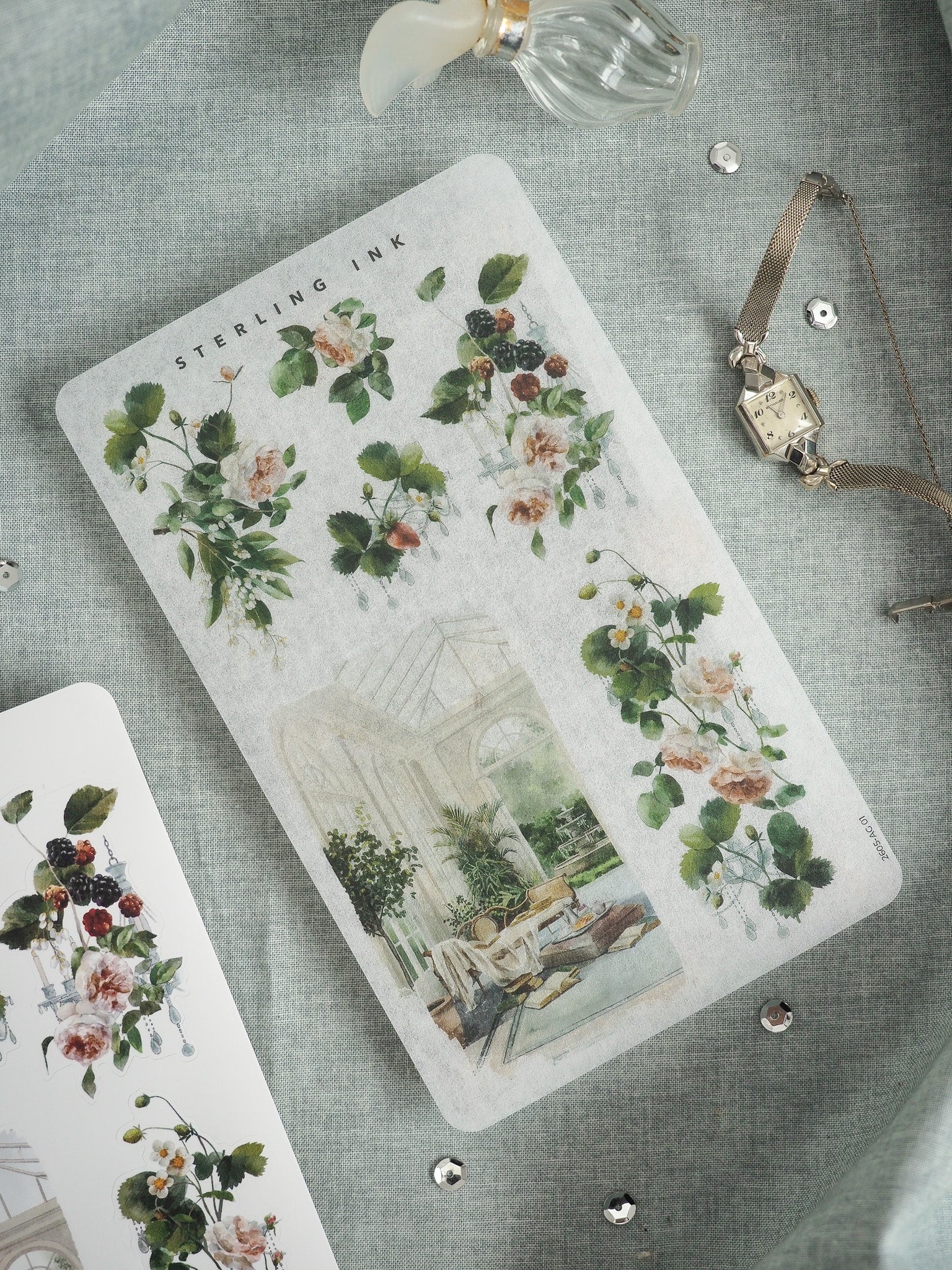 Vintage botanical illustration card by Sterling Ink, featuring watercolor sketches of roses and dark berries above a detailed central drawing of a lush, ornate glass conservatory.