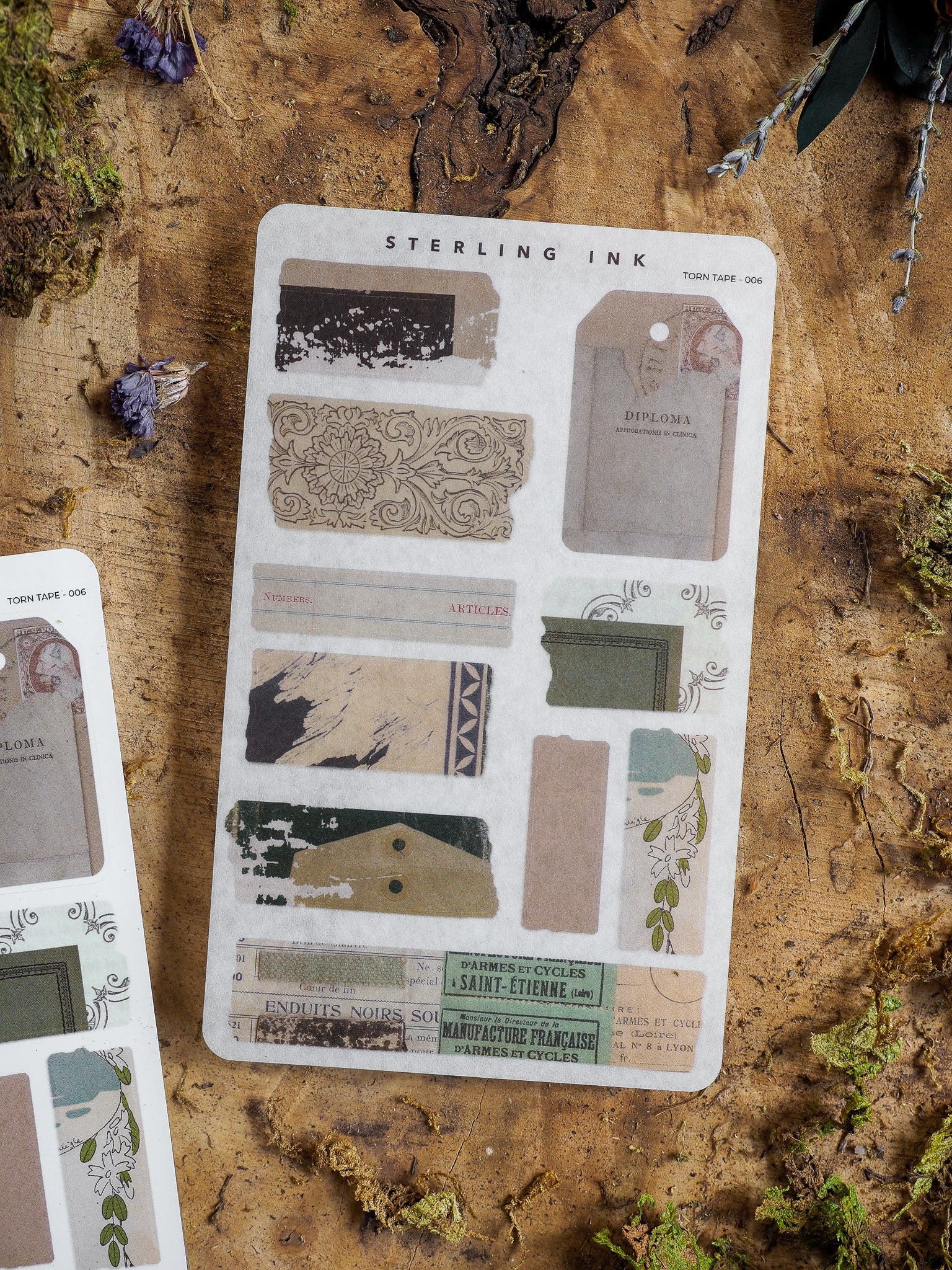 A vintage "Sterling Ink" sticker sheet featuring sepia-toned distressed grunge patches, ornate diploma seals, and retro French labels perfect for journaling and scrapbooking.