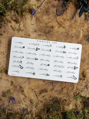 Black ink weekly planner stickers featuring delicate, scattered hand-drawn floral motifs and days of the week, ideal for journaling or organizing June 2025.