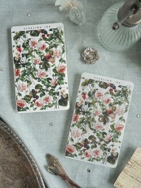Floral botanical prints featuring a dense, romantic pattern of blush pink roses, lush greenery, and dark berries, ideal for scrapbooking or journaling.