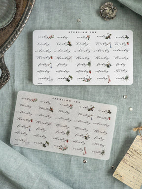 Set of two delicate, printable floral stickers from Sterling Ink, featuring repeating vintage patterns of small wildflowers and leaves on white paper.